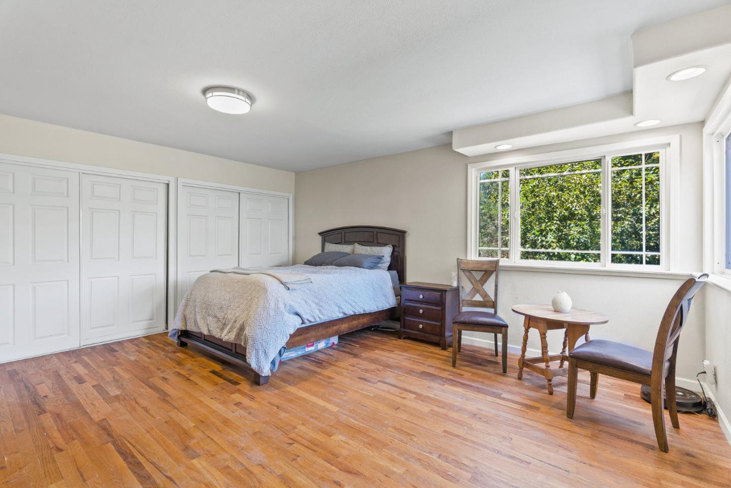 129 Browns Valley Road, Unit A Watsonville, CA 95076 - Photo 28 of 45 a bedroom with a bed and a chair