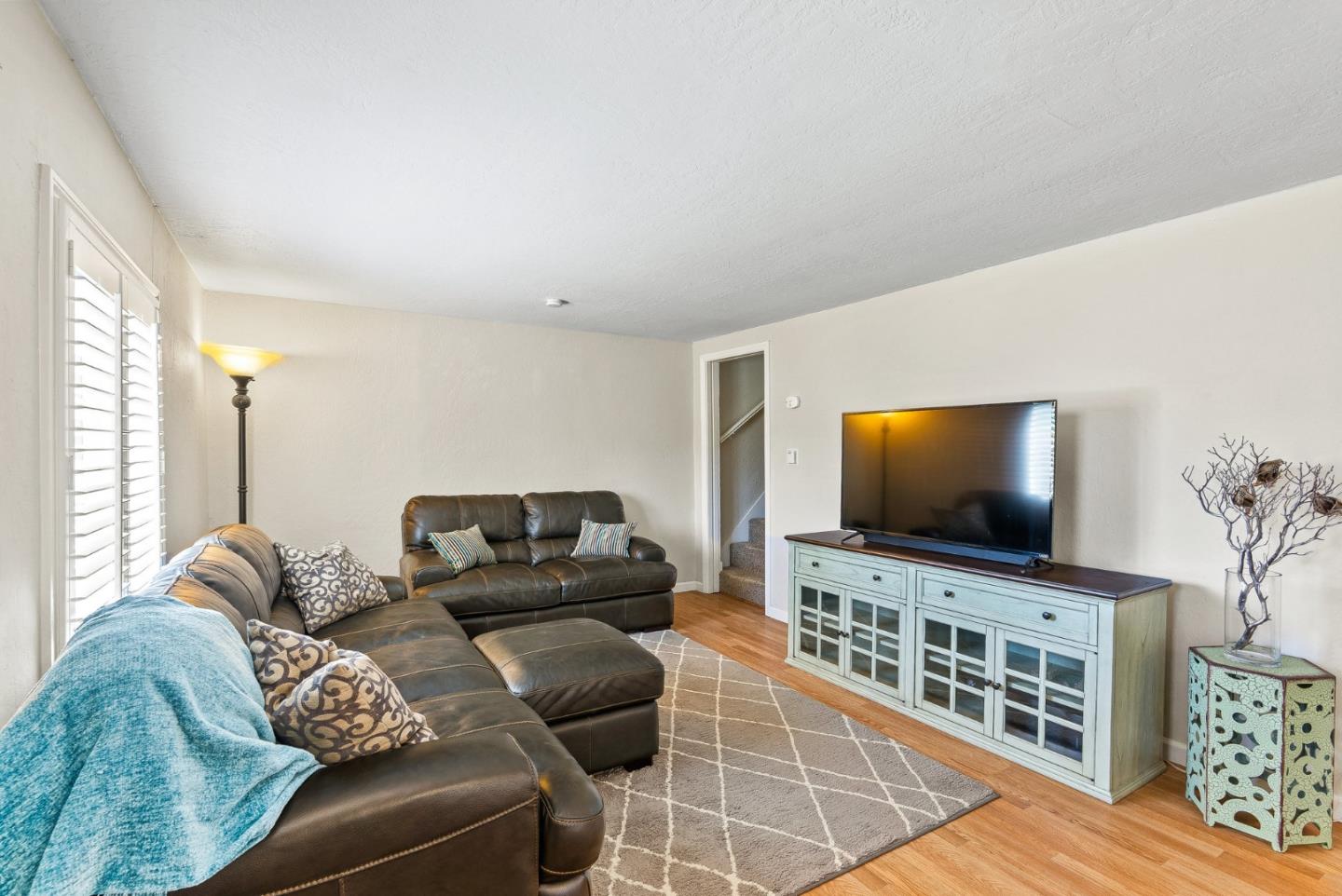 129 Browns Valley Road, Unit A Watsonville, CA 95076 - Photo 5 of 45 a living room with furniture and a flat screen tv