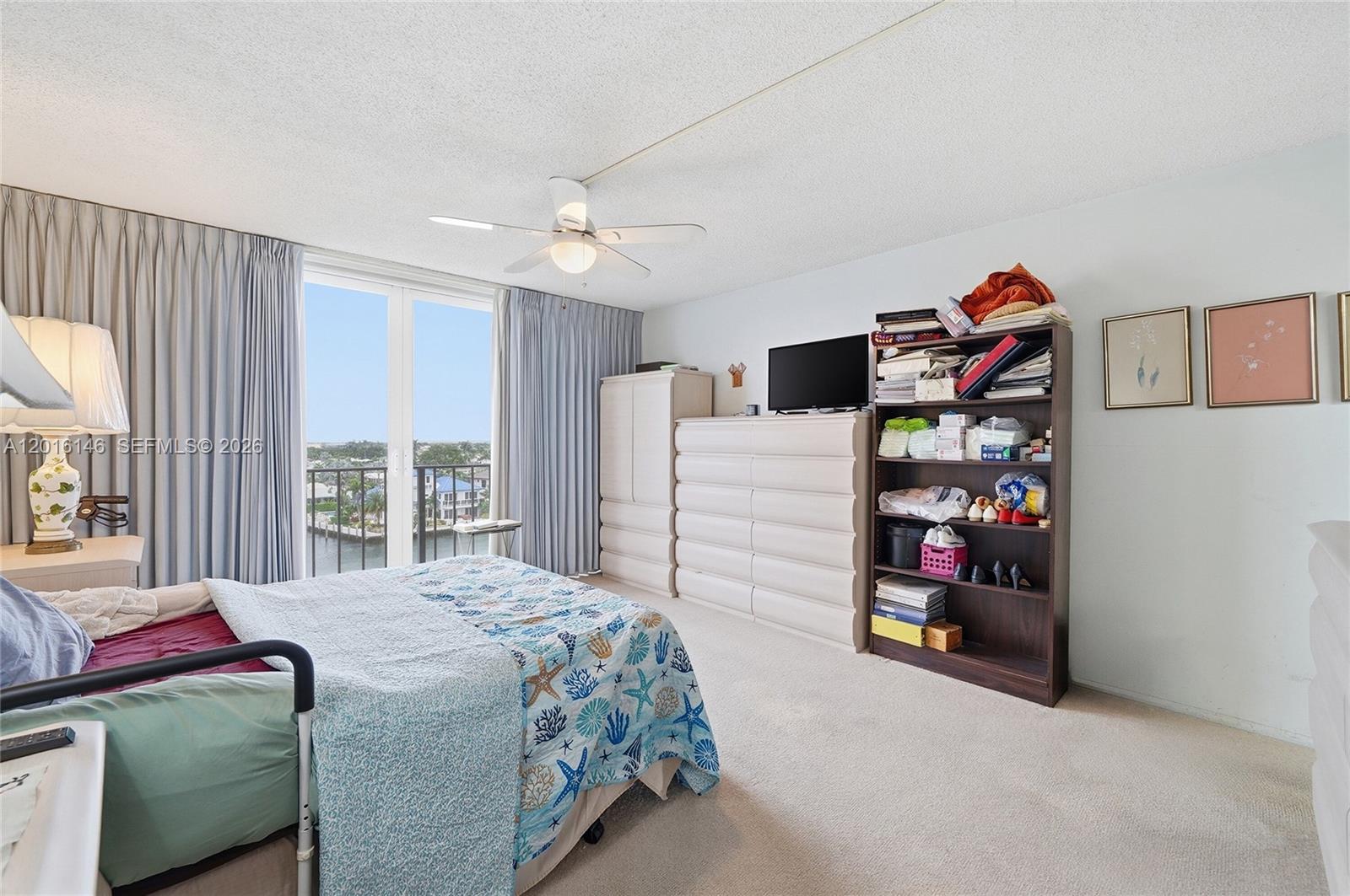 521 North Riverside Drive, Unit 606 Pompano Beach, FL 33062 - Photo 16 of 50 a bedroom with a bed and a cabinets