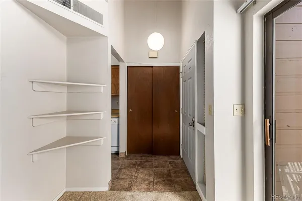an empty room with windows and closet