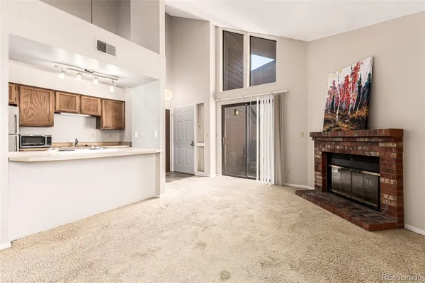 a large kitchen with granite countertop a stove and a refrigerator