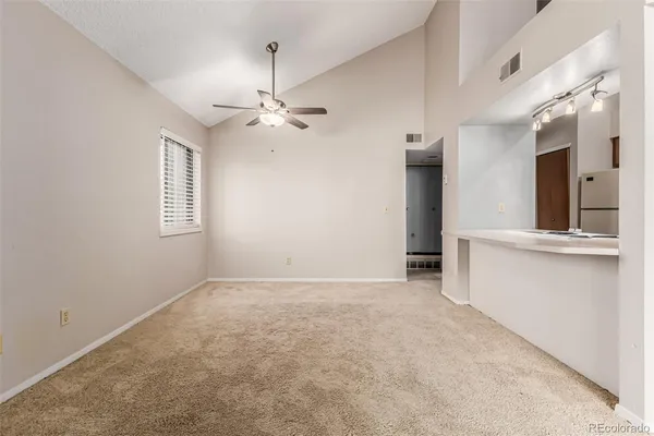 an empty room with windows and fireplace