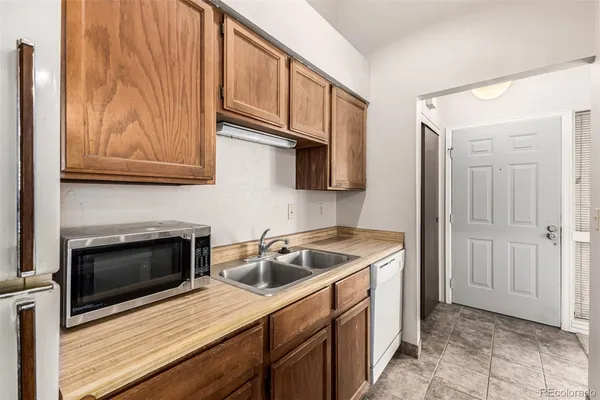 a kitchen with stainless steel appliances a stove a sink and a refrigerator
