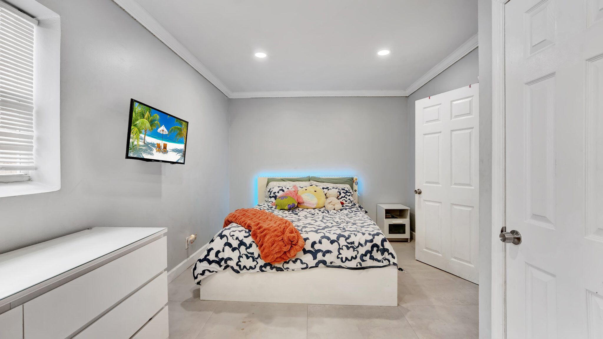 9709 Southwest 1st Place Boca Raton, FL 33428 - Photo 13 of 32 a bedroom with a bed and a window