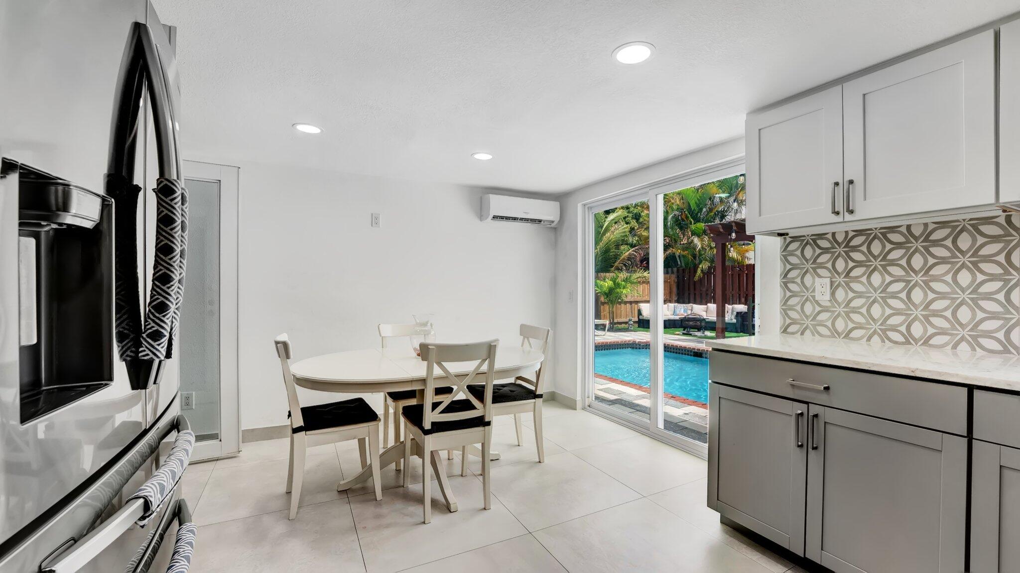 9709 Southwest 1st Place Boca Raton, FL 33428 - Photo 19 of 32 a kitchen with stainless steel appliances kitchen island granite countertop a sink and cabinets