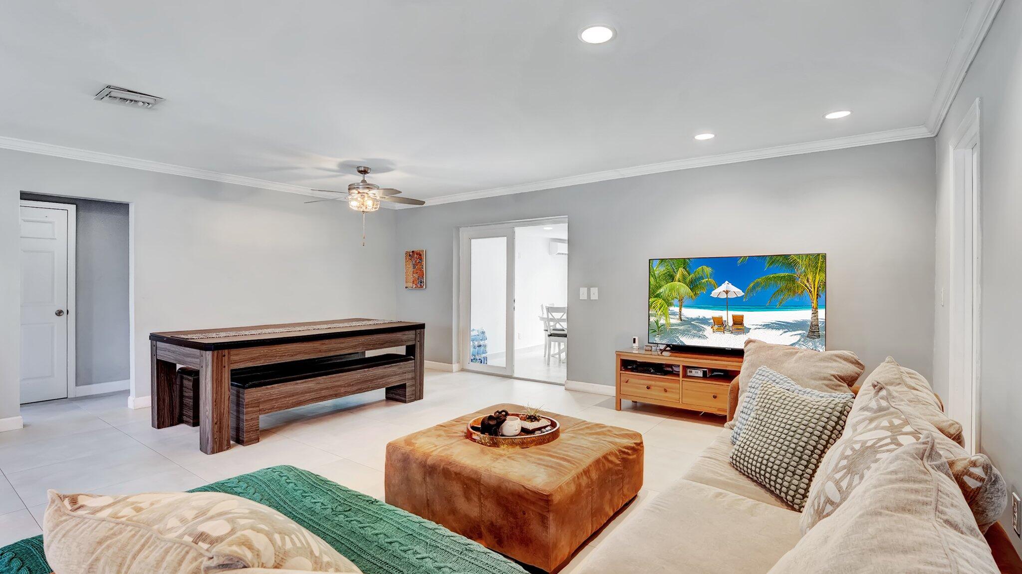 9709 Southwest 1st Place Boca Raton, FL 33428 - Photo 6 of 32 a living room with furniture and a flat screen tv