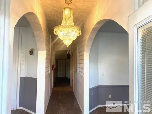 a view of hallway with livingroom and furniture