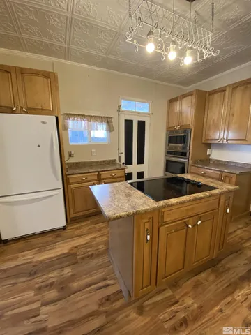 a kitchen with stainless steel appliances granite countertop a refrigerator and a stove