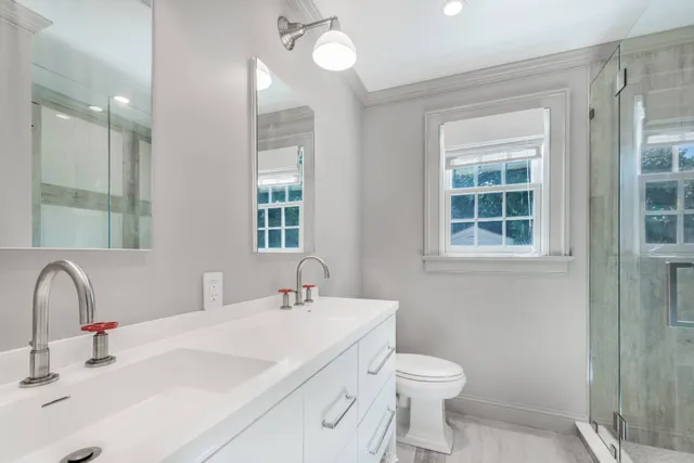 a bathroom with a sink toilet and shower