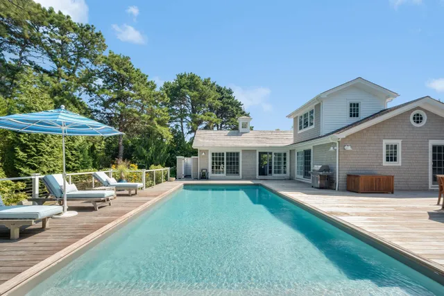 a view of a house with a yard patio and fire pit