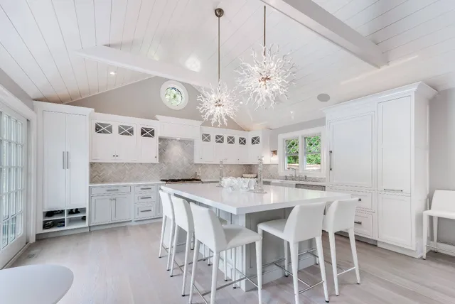 a kitchen with stainless steel appliances kitchen island granite countertop a stove a table and chairs in it