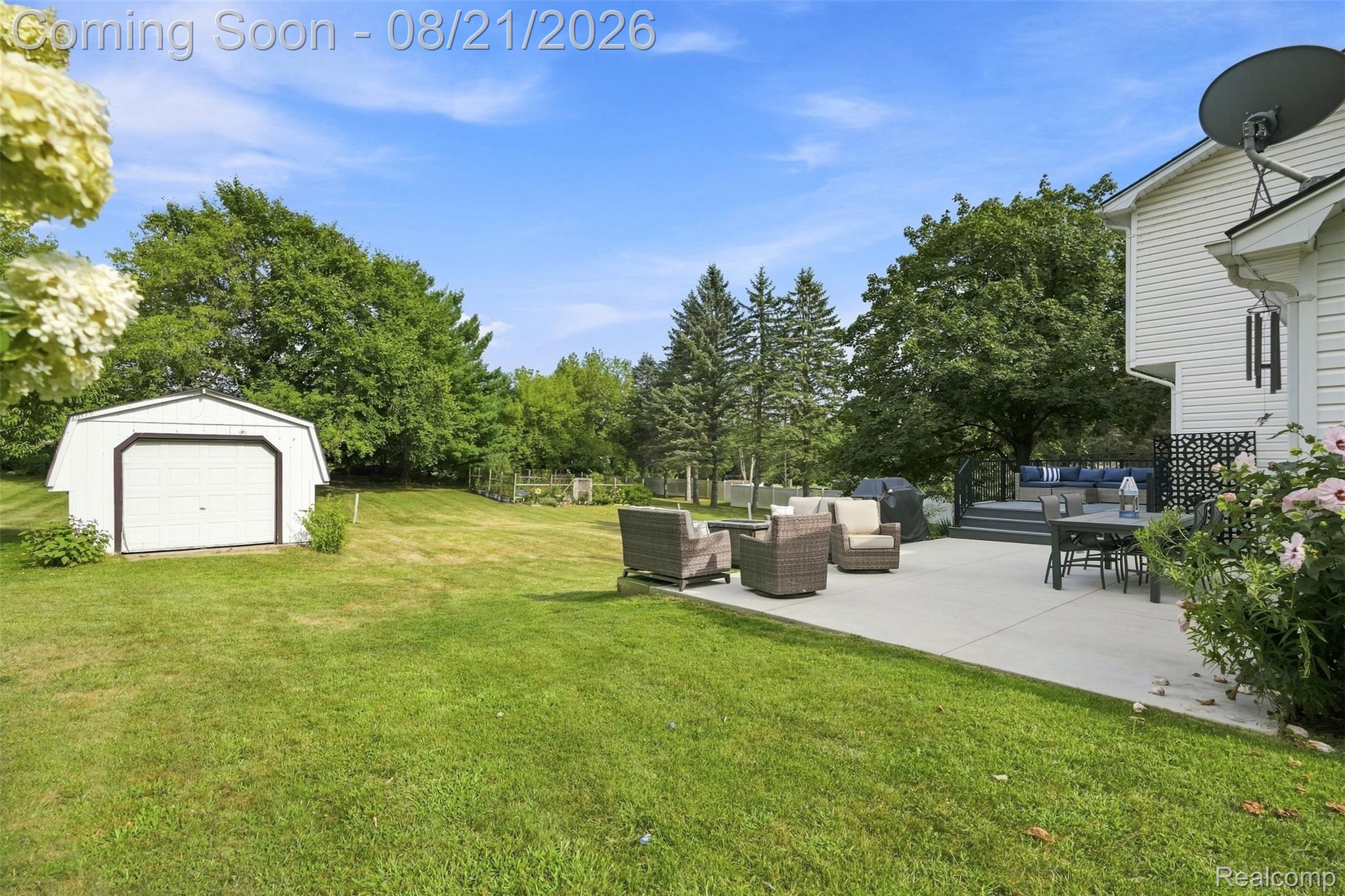 6060 Ford Road Commerce Township, MI 48382 - Photo 37 of 58 Expansive lawn with a detached storage shed, concrete patio, and an elevated composite deck