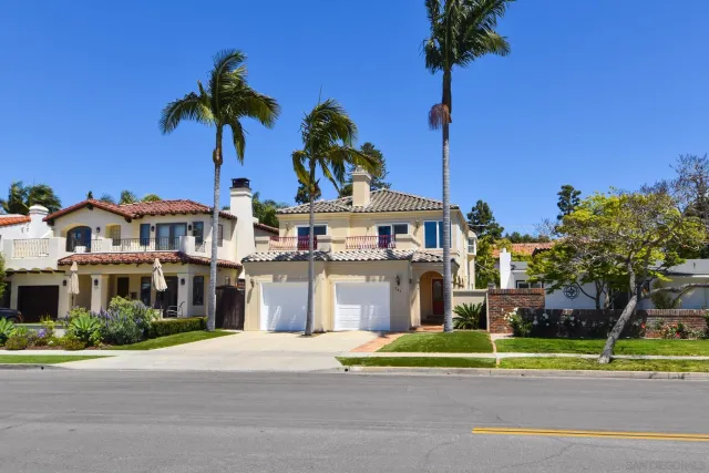 a front view of a house with a garden and trees