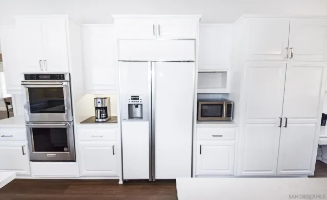 a kitchen with stainless steel appliances a refrigerator stove and microwave