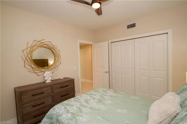 a bedroom with a bed and a mirror