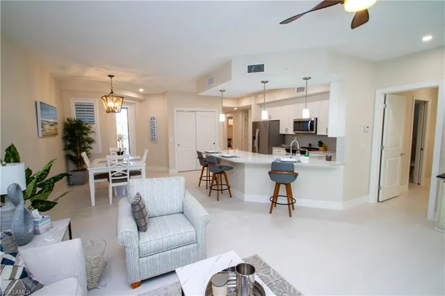 a living room with furniture and a large mirror