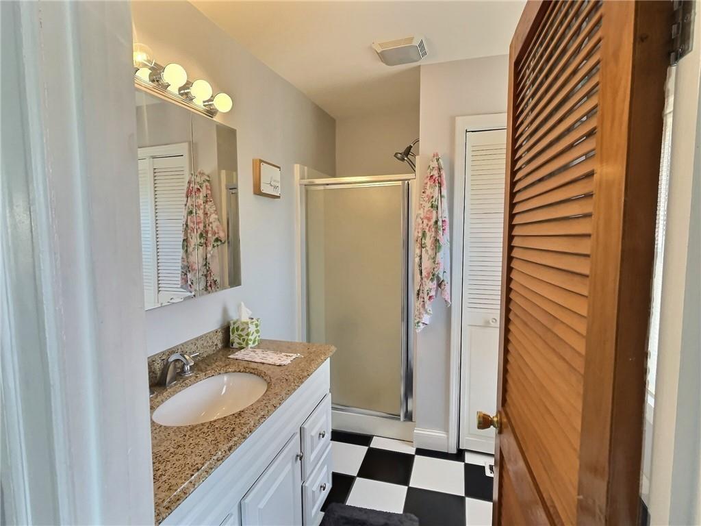 724 Washington Street, Unit 2 Sewickley, PA 15143 - Photo 12 of 18 a bathroom with a granite countertop sink and a mirror