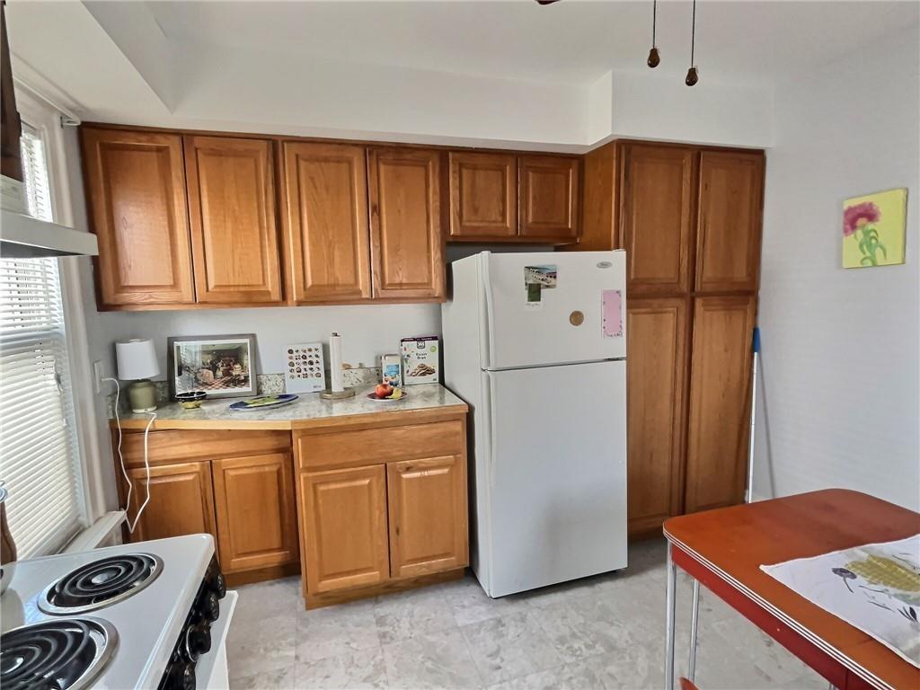 724 Washington Street, Unit 2 Sewickley, PA 15143 - Photo 7 of 18 a utility room with wooden floor and cabinets