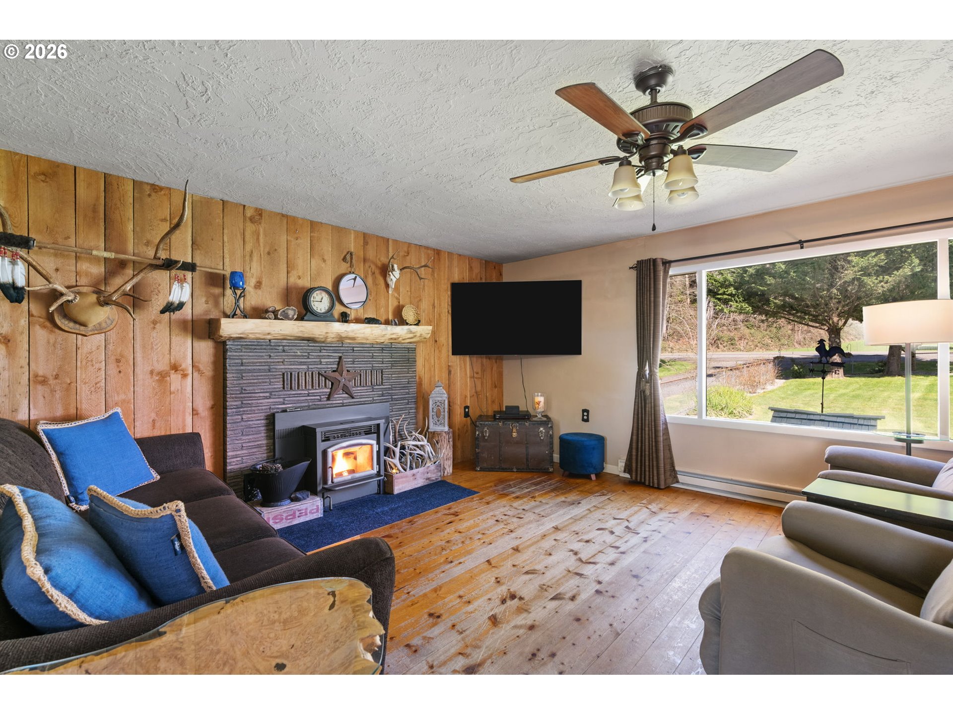 15052 Lewis River Road Ariel, WA 98603 - Photo 10 of 40 a living room with furniture a flat screen tv and a fireplace