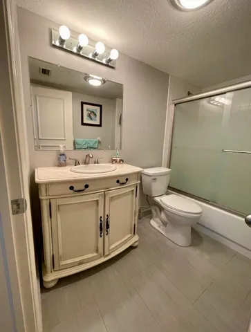 a bathroom with a sink toilet and mirror