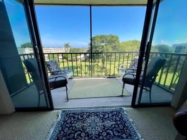 a view of a balcony with chairs