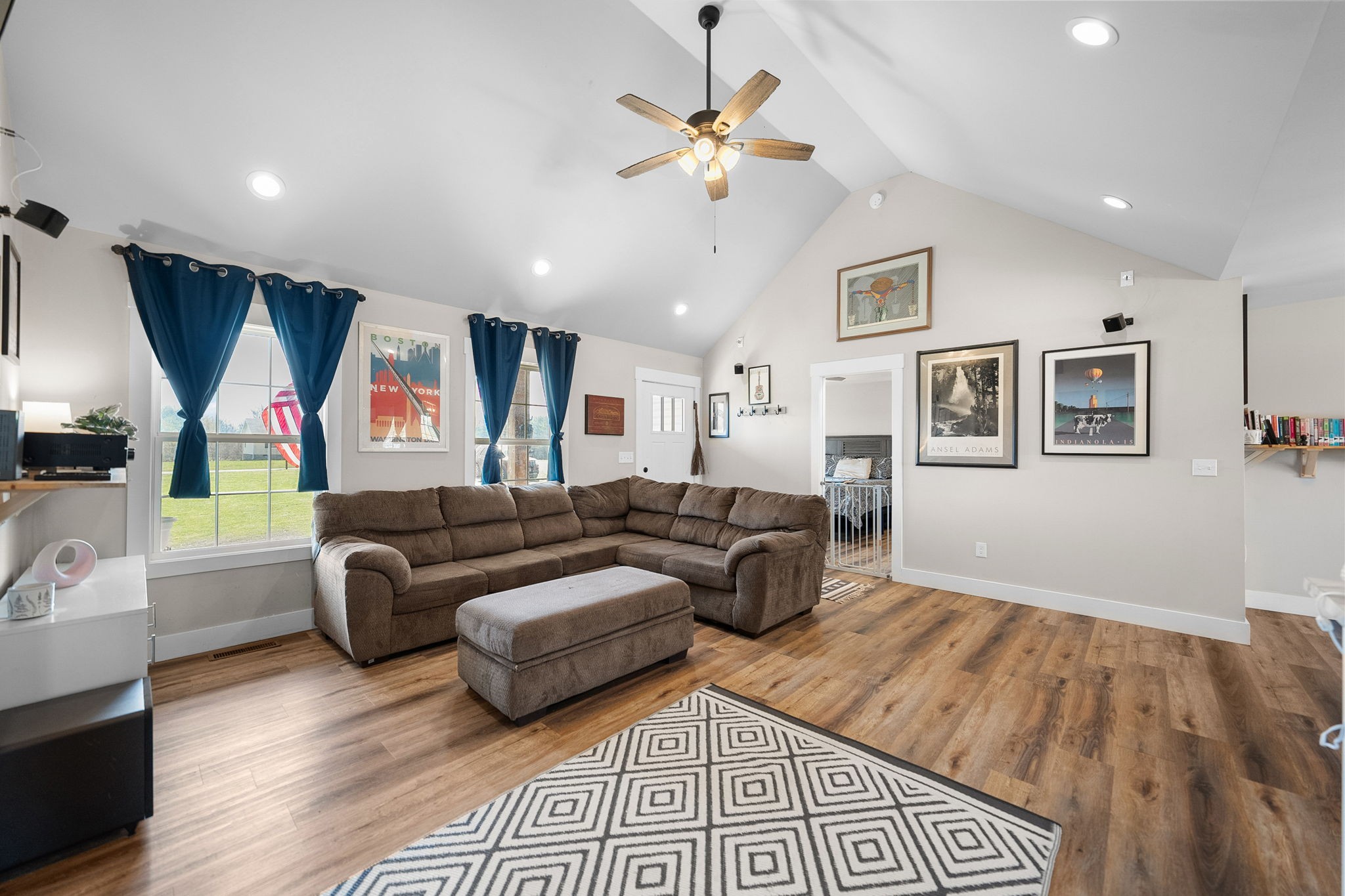 a living room with furniture and a wooden floor