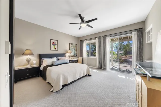 a bedroom with a bed and large window