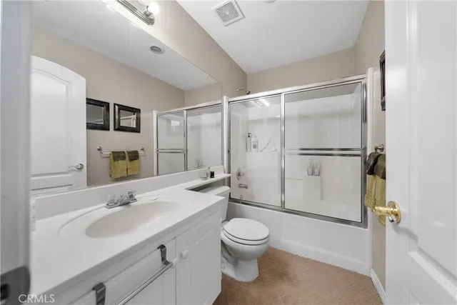 a living room with furniture and a lamp