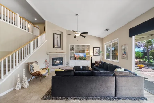a living room with furniture a chandelier and a fireplace