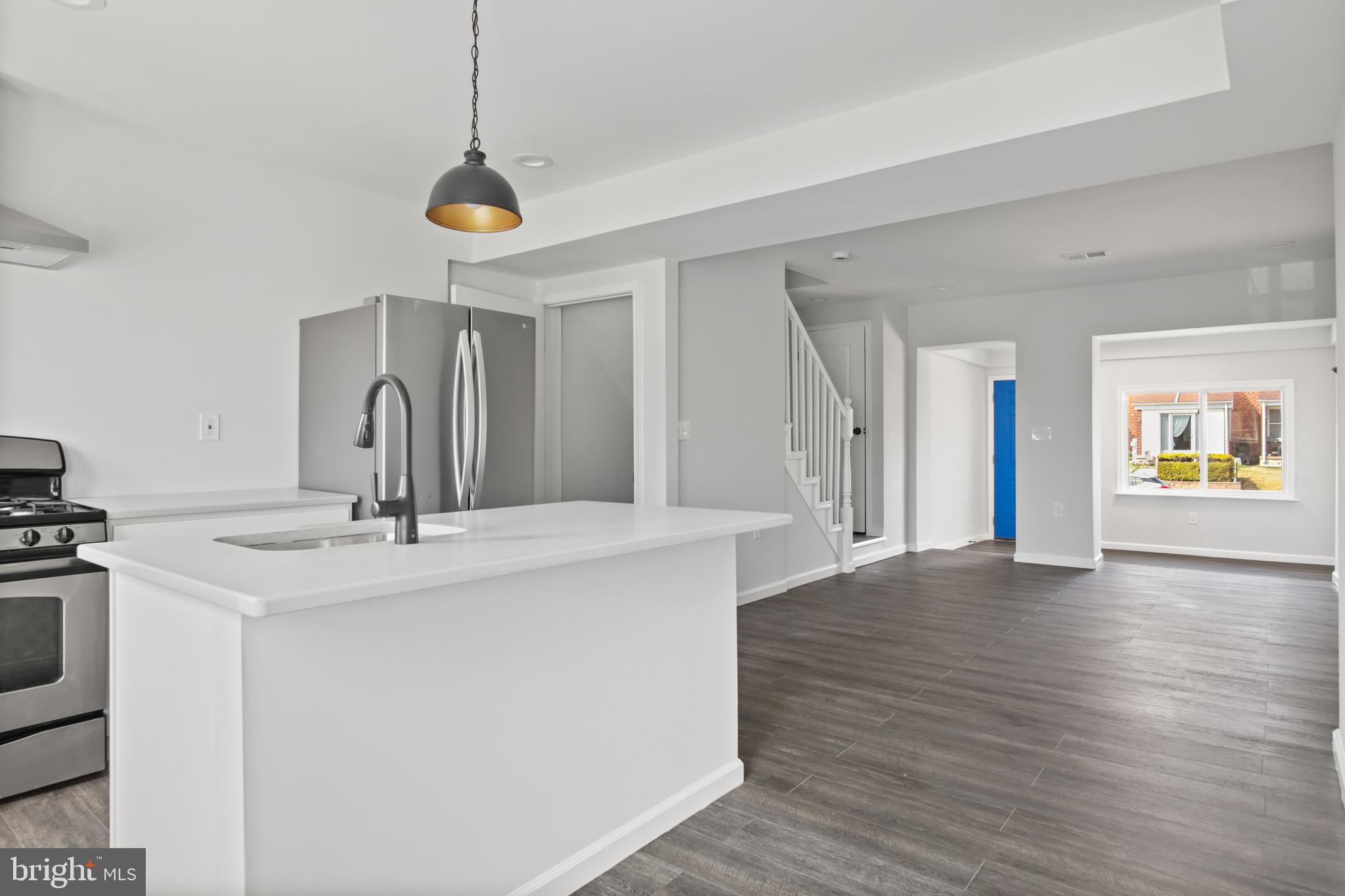 7841 Charlesmont Road Baltimore, MD 21222 - Photo 12 of 43 a view of a kitchen with a sink wooden floor and a living room