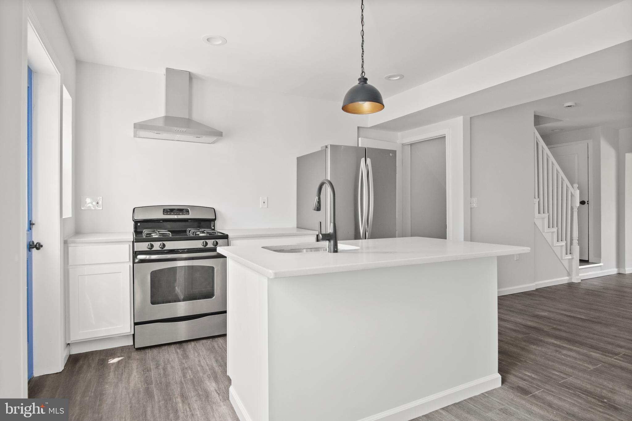 7841 Charlesmont Road Baltimore, MD 21222 - Photo 13 of 43 a kitchen with stainless steel appliances a stove a sink and a refrigerator