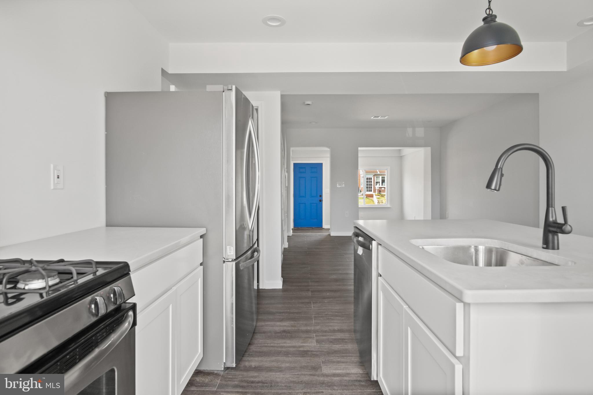 7841 Charlesmont Road Baltimore, MD 21222 - Photo 14 of 43 a kitchen with a sink and a stove top oven
