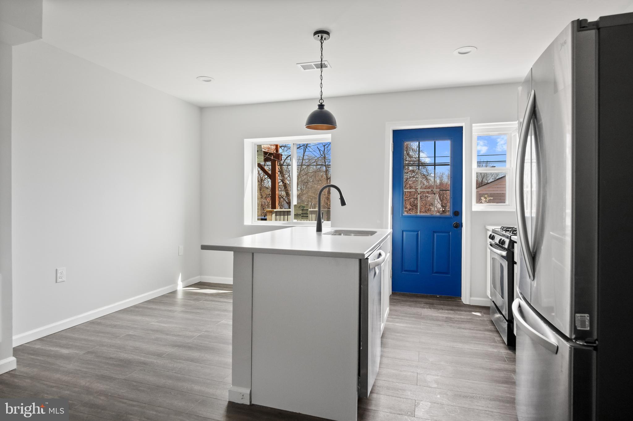 7841 Charlesmont Road Baltimore, MD 21222 - Photo 15 of 43 a kitchen with sink refrigerator and window