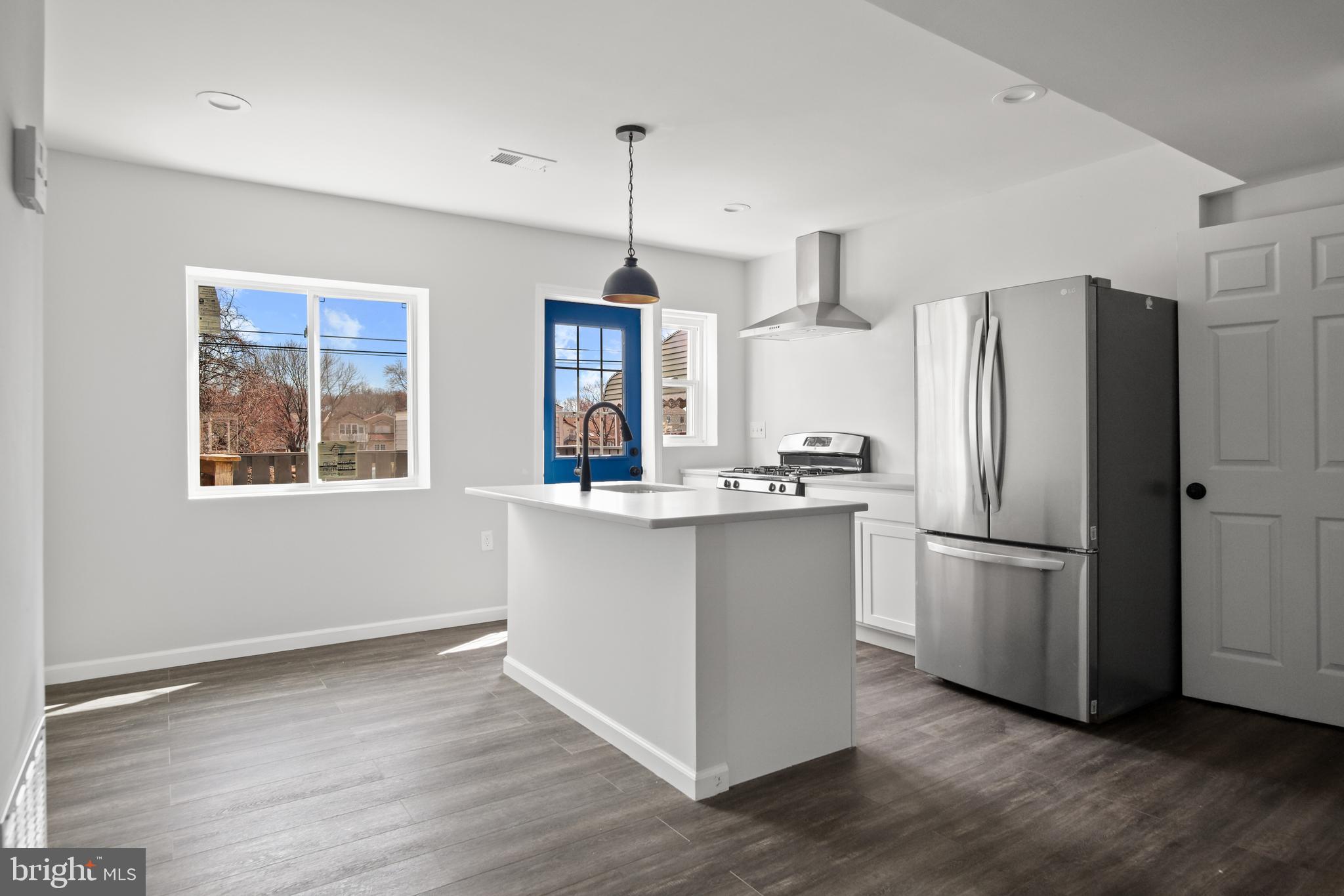 7841 Charlesmont Road Baltimore, MD 21222 - Photo 16 of 43 a kitchen with stainless steel appliances granite countertop a refrigerator a stove a sink and a window