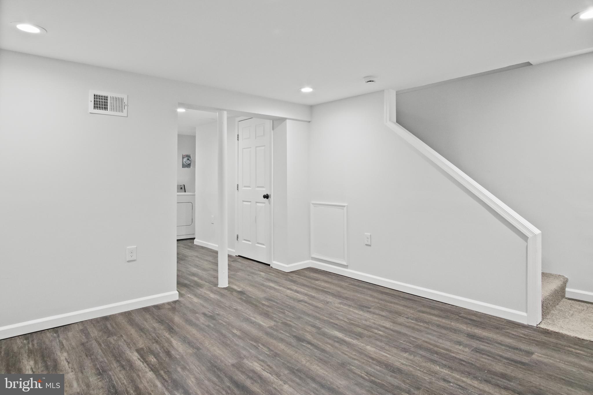 7841 Charlesmont Road Baltimore, MD 21222 - Photo 20 of 43 a view of an empty room with wooden floor