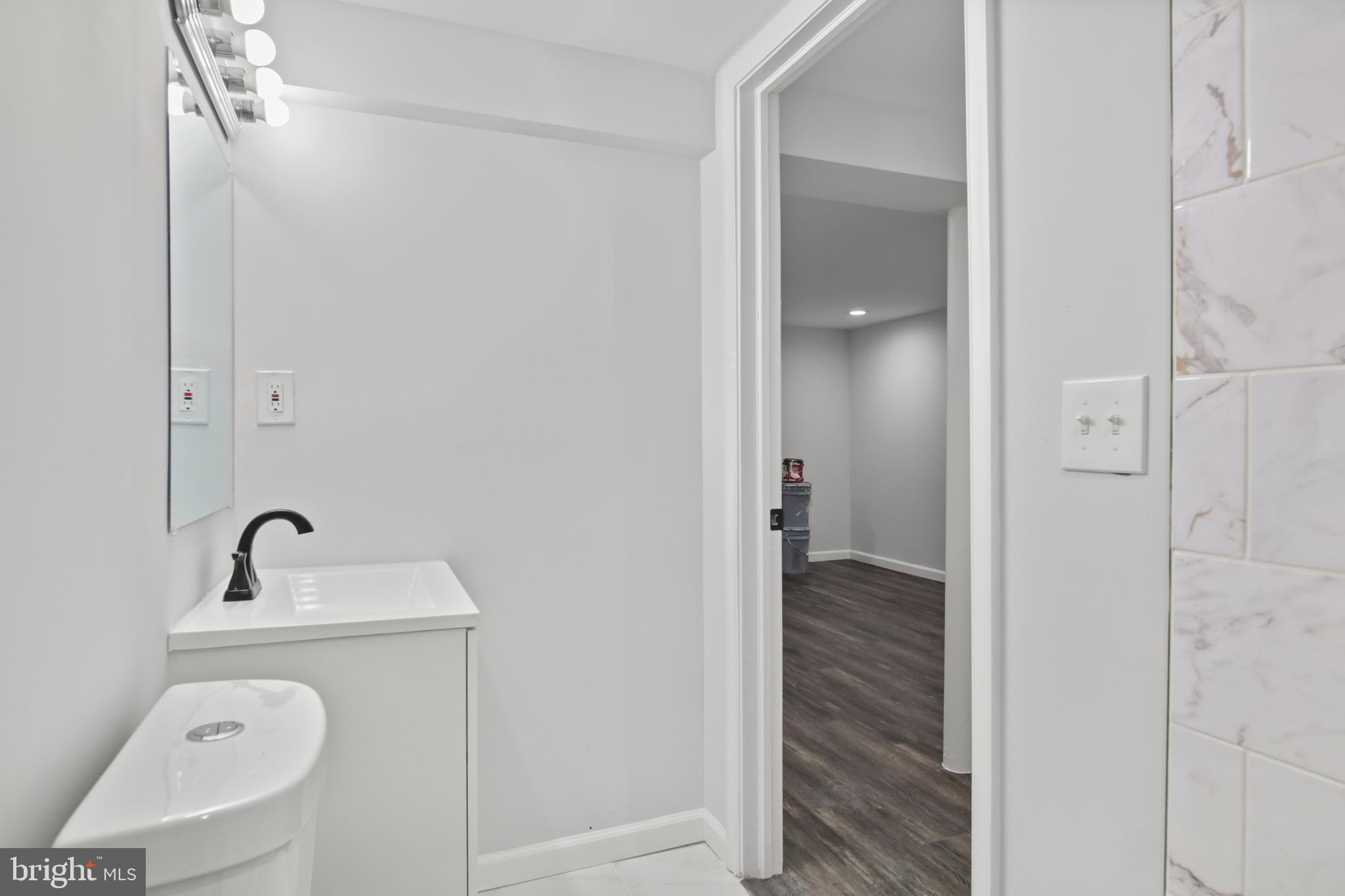 7841 Charlesmont Road Baltimore, MD 21222 - Photo 27 of 43 a bathroom with a sink and toilet