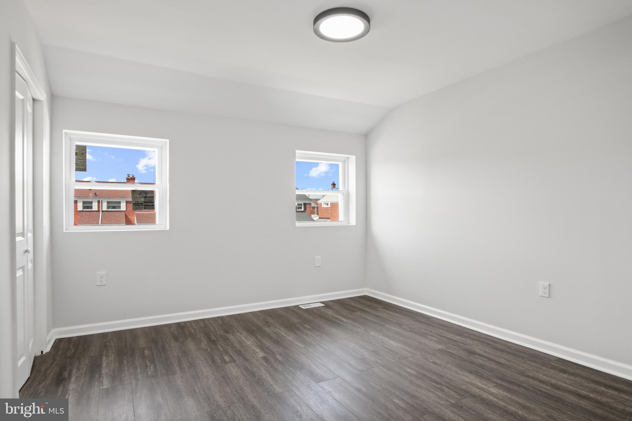 7841 Charlesmont Road Baltimore, MD 21222 - Photo 28 of 43 an empty room with wooden floor and windows