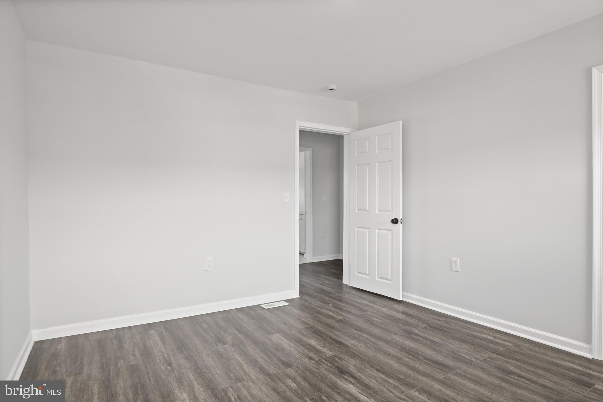 7841 Charlesmont Road Baltimore, MD 21222 - Photo 29 of 43 a view of an empty room and wooden floor