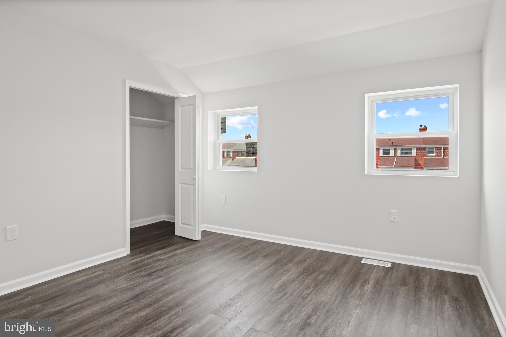 7841 Charlesmont Road Baltimore, MD 21222 - Photo 31 of 43 an empty room with wooden floor and windows
