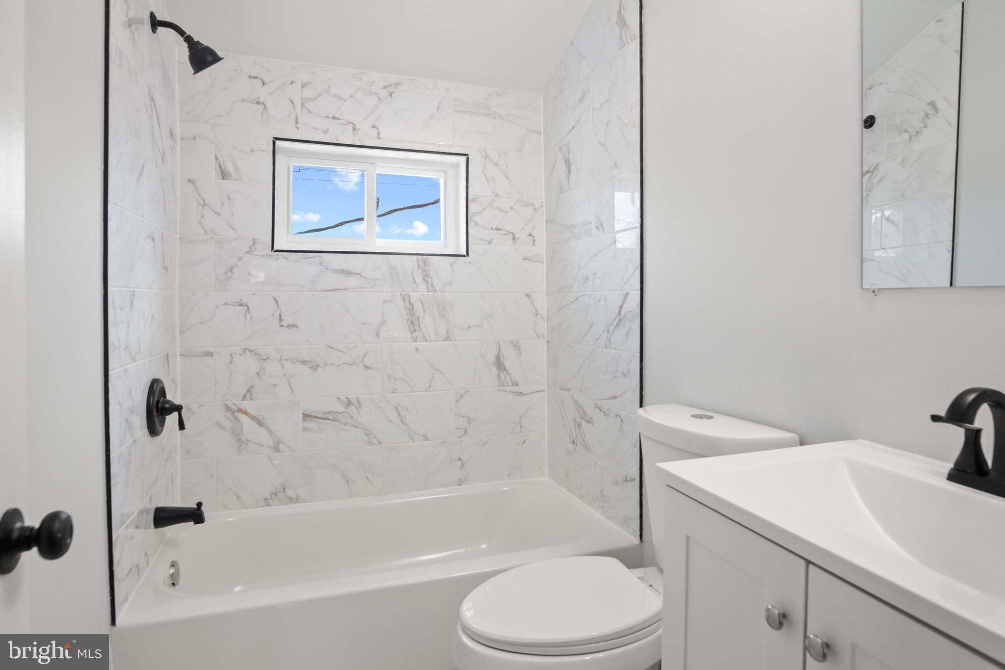 7841 Charlesmont Road Baltimore, MD 21222 - Photo 35 of 43 a bathroom with a toilet sink and bathtub