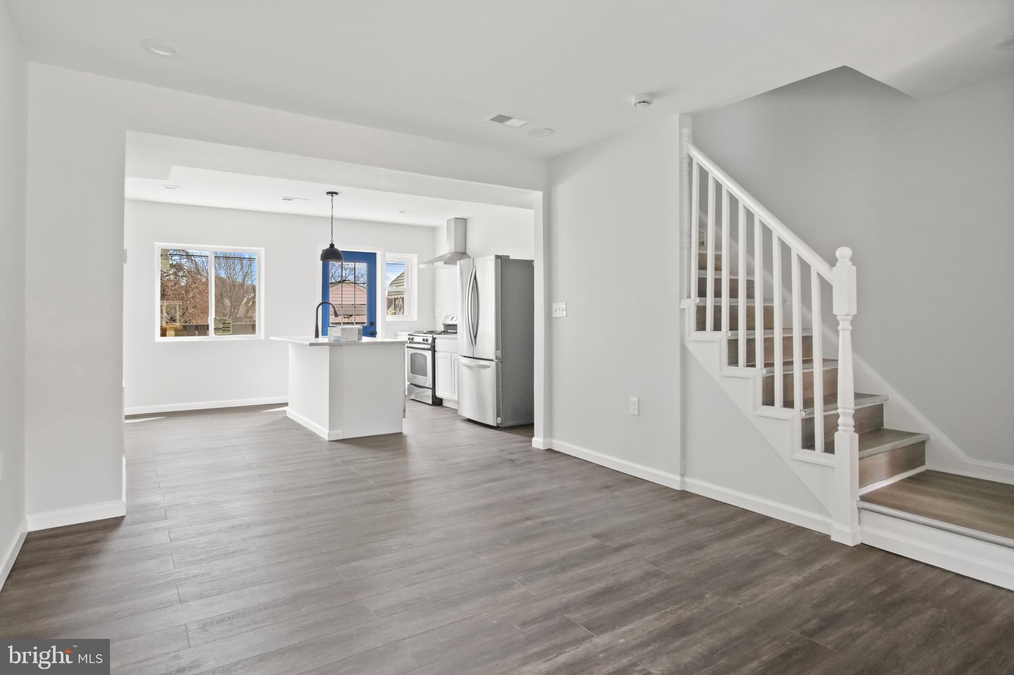 7841 Charlesmont Road Baltimore, MD 21222 - Photo 8 of 43 a view of empty room with wooden floor and windows