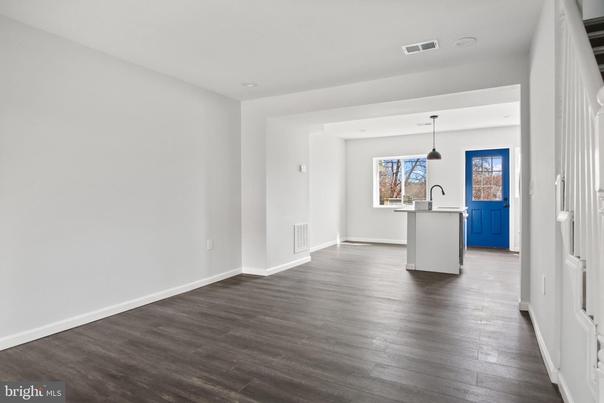 7841 Charlesmont Road Baltimore, MD 21222 - Photo 9 of 43 a view of a kitchen with wooden floor and a refrigerator