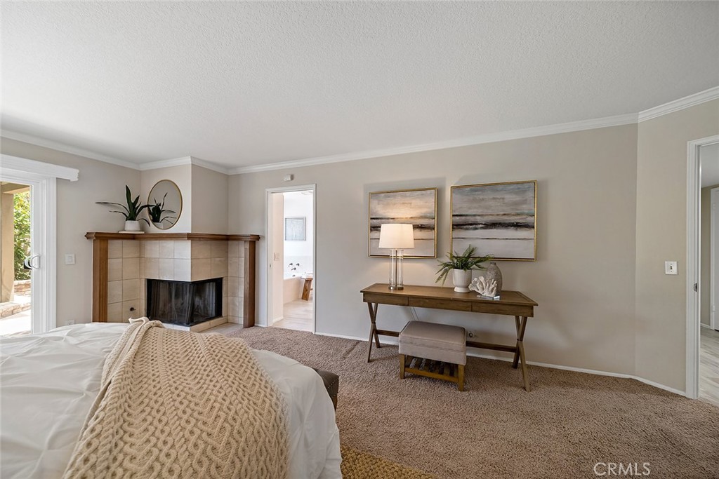 6247 Majorca Circle Long Beach, CA 90803 - Photo 33 of 57 a bedroom with a bed and a fireplace