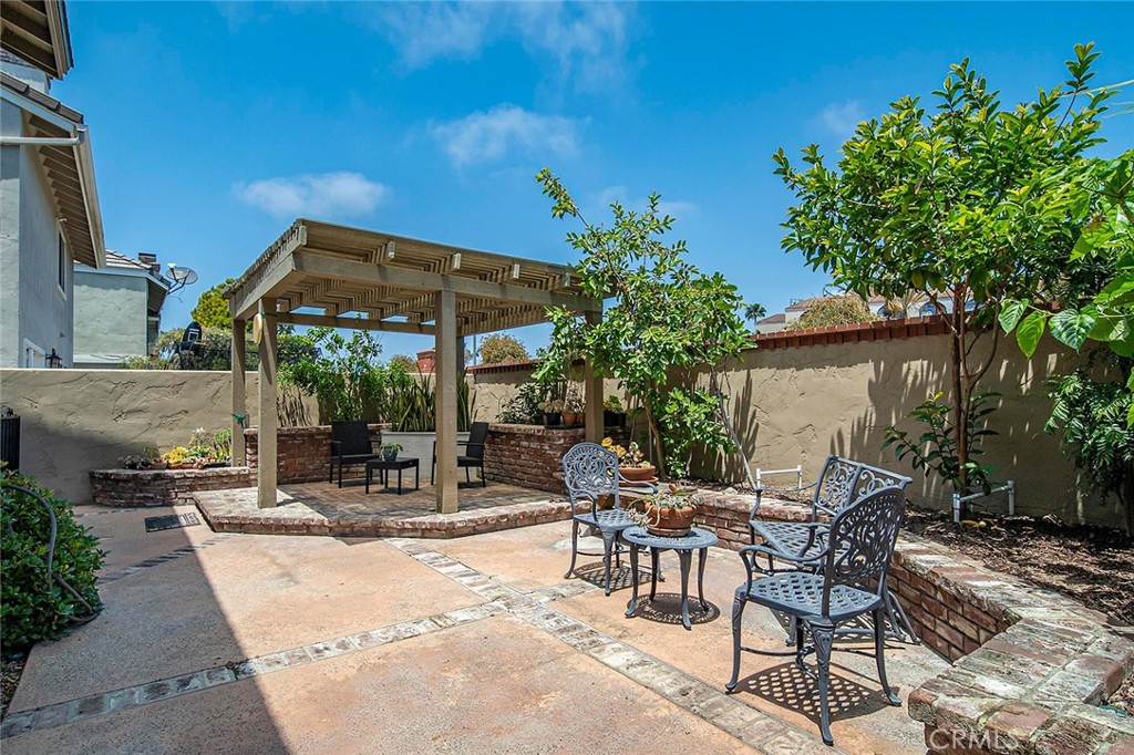 6247 Majorca Circle Long Beach, CA 90803 - Photo 43 of 57 a view of patio with a table and chairs under an umbrella