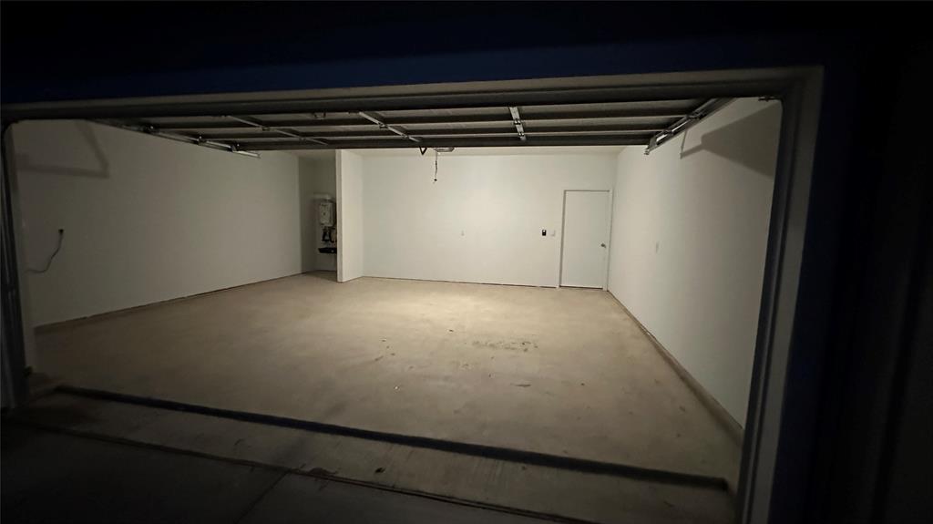 204 Inks Lane Kyle, TX 78640 - Photo 21 of 25 A spacious, bare garage awaits customization.