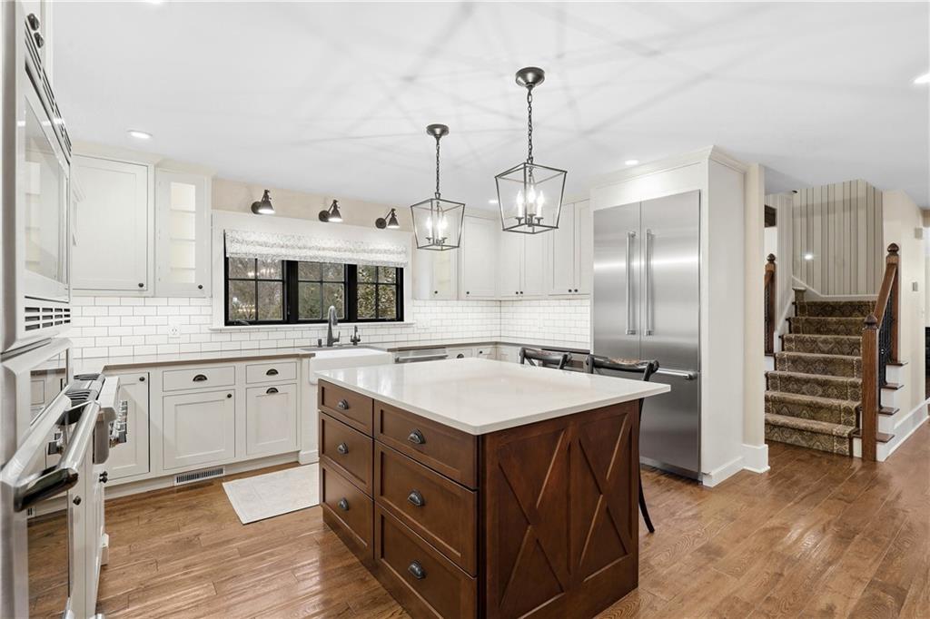 411 Woodland Road Sewickley, PA 15143 - Photo 14 of 46 a kitchen with a stove a refrigerator and a sink