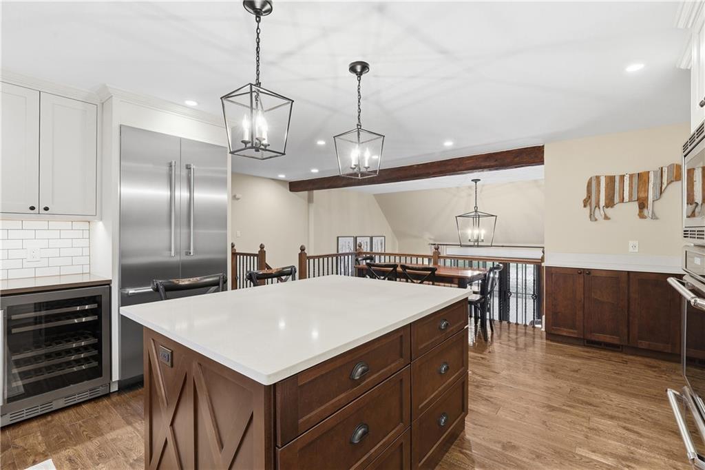 411 Woodland Road Sewickley, PA 15143 - Photo 15 of 46 a kitchen with a stove a refrigerator and chairs