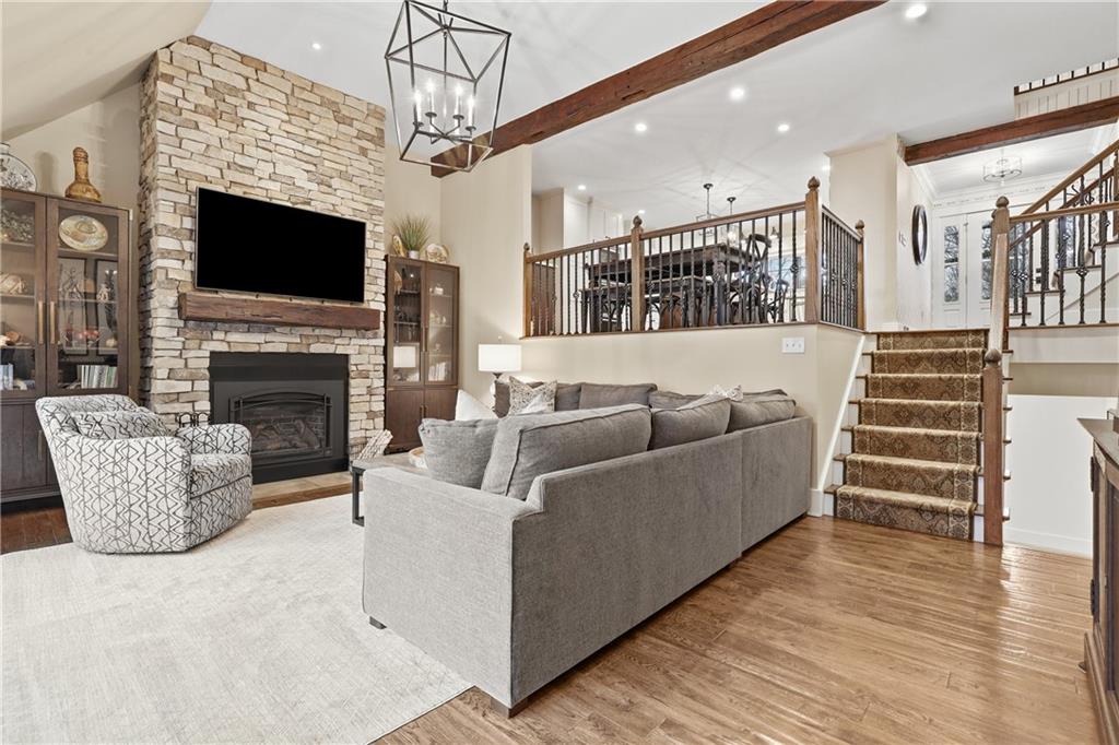 411 Woodland Road Sewickley, PA 15143 - Photo 19 of 46 a living room with furniture a flat screen tv and a fireplace