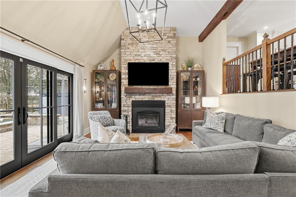 411 Woodland Road Sewickley, PA 15143 - Photo 20 of 46 a living room with furniture a fireplace and a floor to ceiling window