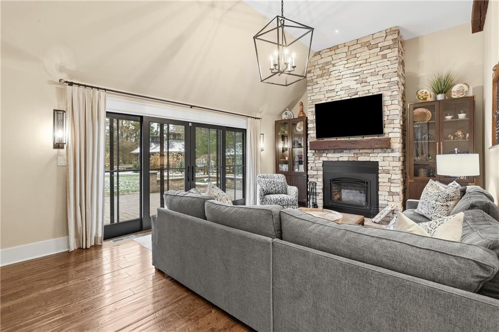 411 Woodland Road Sewickley, PA 15143 - Photo 22 of 46 a living room with furniture a flat screen tv and a fireplace